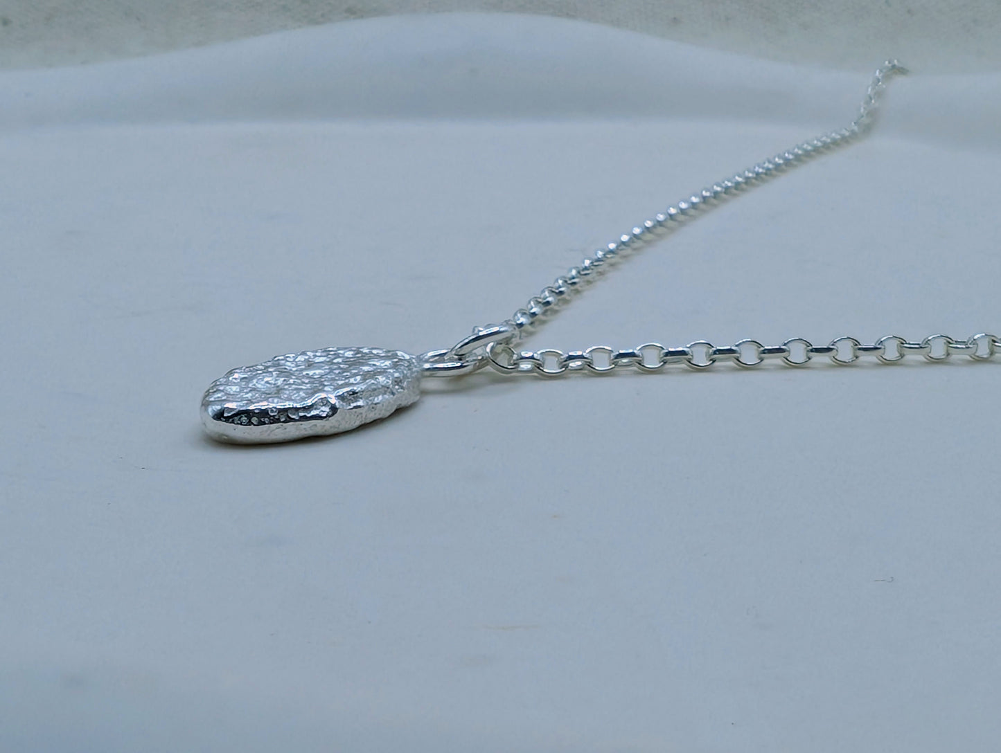 Sandcast silver oval pendant